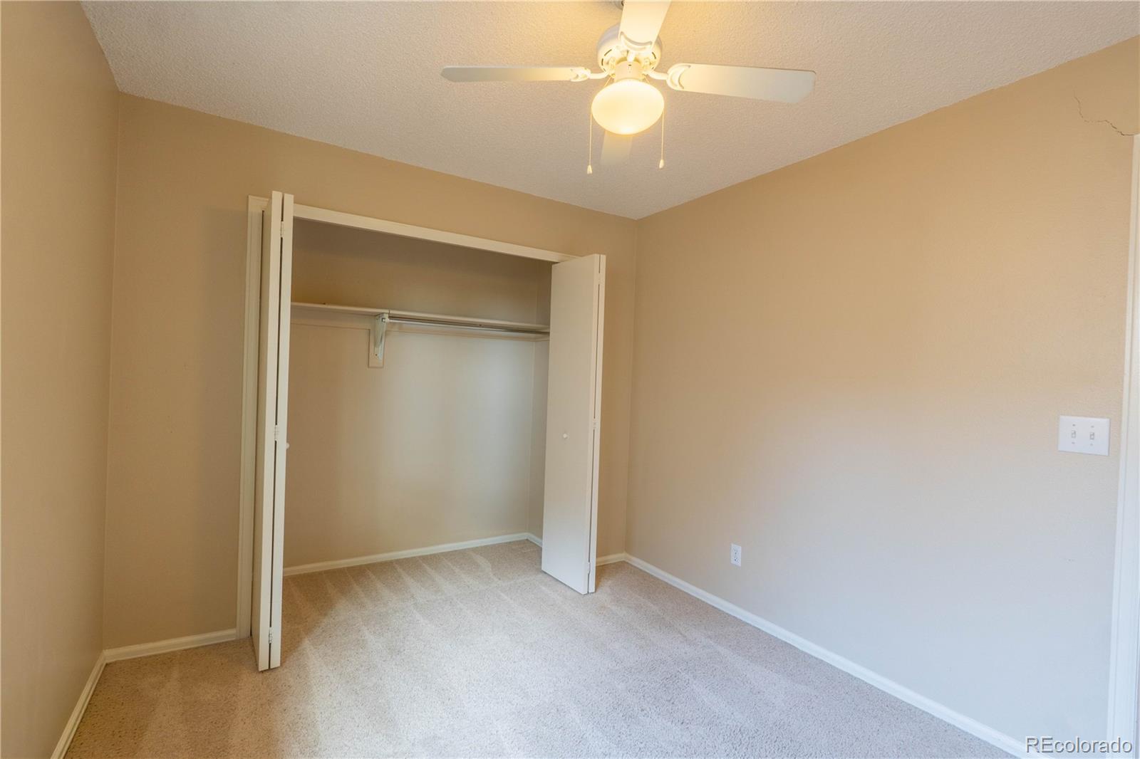961 Columbine Avenue Colorado Springs, CO 80904 - Photo 42 of 47 an empty room with a empty space and a ceiling fan
