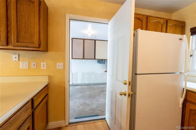 a white refrigerator freezer sitting inside of a kitchen