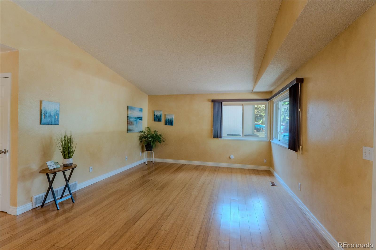 961 Columbine Avenue Colorado Springs, CO 80904 - Photo 5 of 47 a view of an empty room with a window and wooden floor