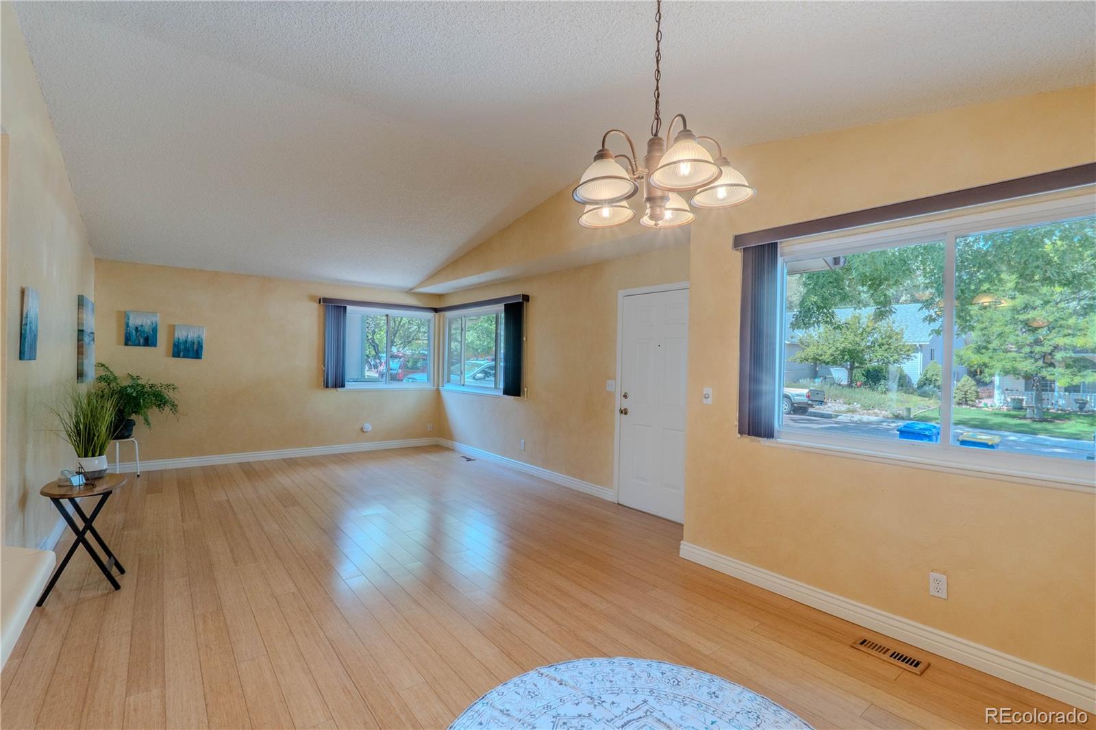 961 Columbine Avenue Colorado Springs, CO 80904 - Photo 9 of 47 a view of a room with wooden floor chandelier and windows