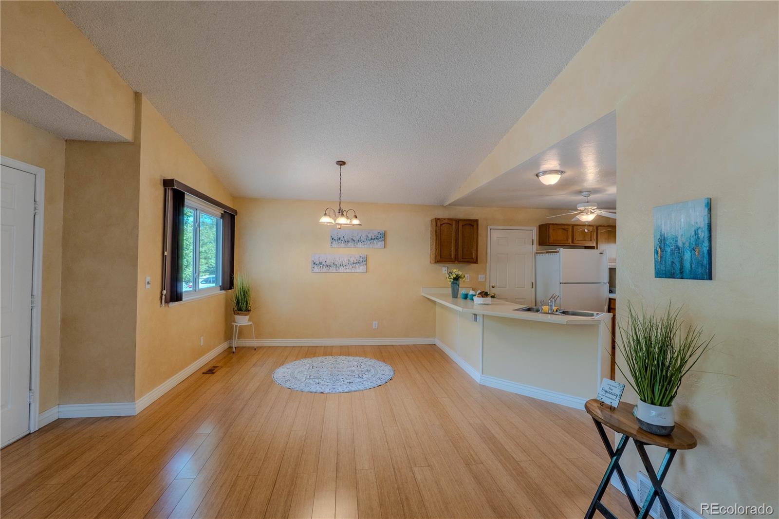 961 Columbine Avenue Colorado Springs, CO 80904 - Photo 10 of 47 a kitchen with stainless steel appliances wooden floor and dining table