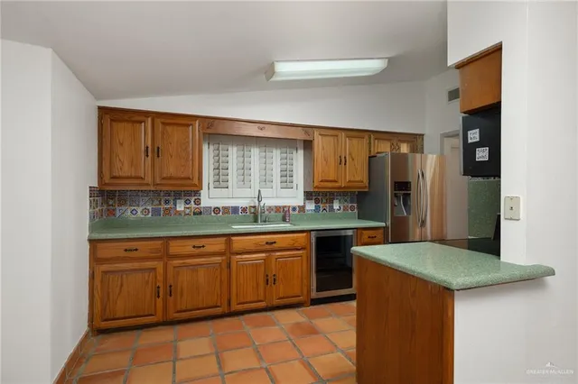 a kitchen with stainless steel appliances granite countertop a sink and a stove