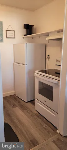 a stove top oven sitting inside of a kitchen