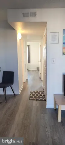 a view of a room with wooden floor and furniture