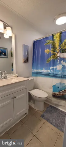 a bathroom with a toilet a sink and a mirror