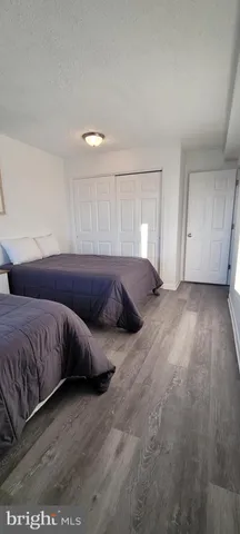 a living room with a bed and cabinets