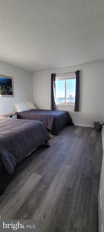 a living room with a bed furniture and dresser