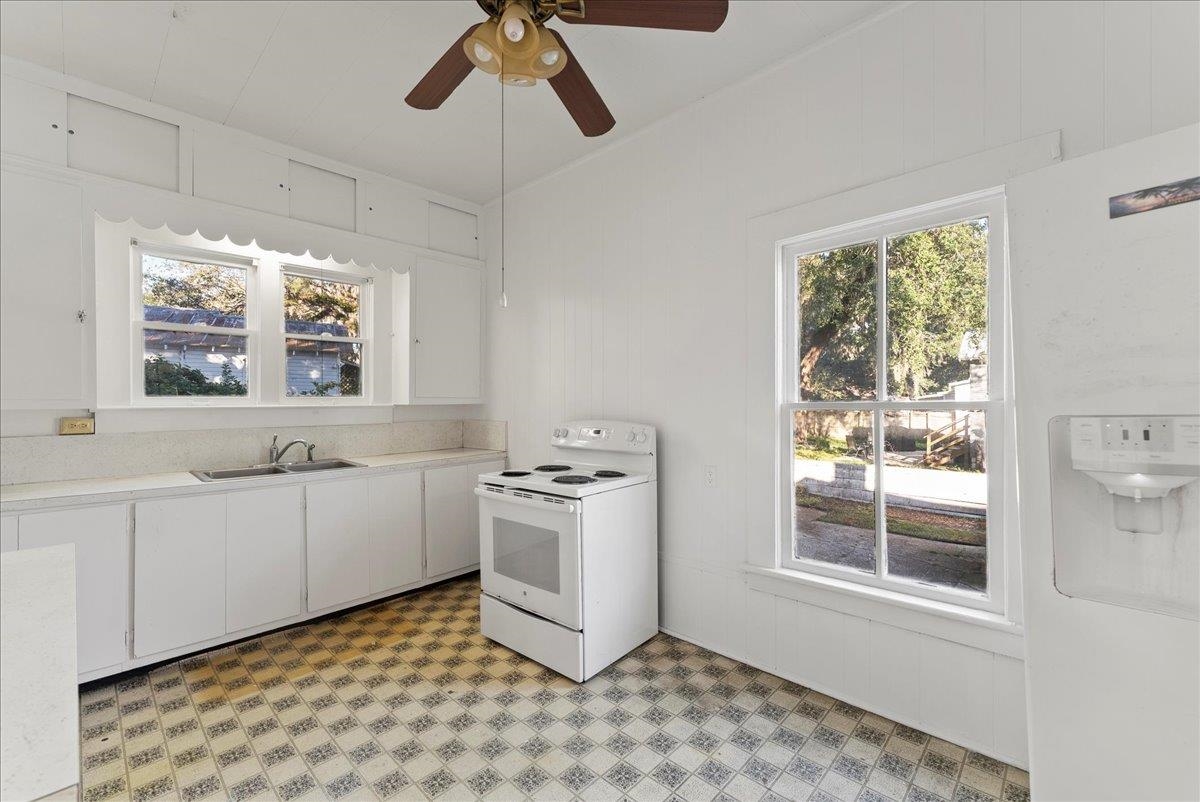 10 Clark Street St. Augustine, FL 32084 - Photo 21 of 44 a kitchen with stainless steel appliances granite countertop a stove a sink and a microwave