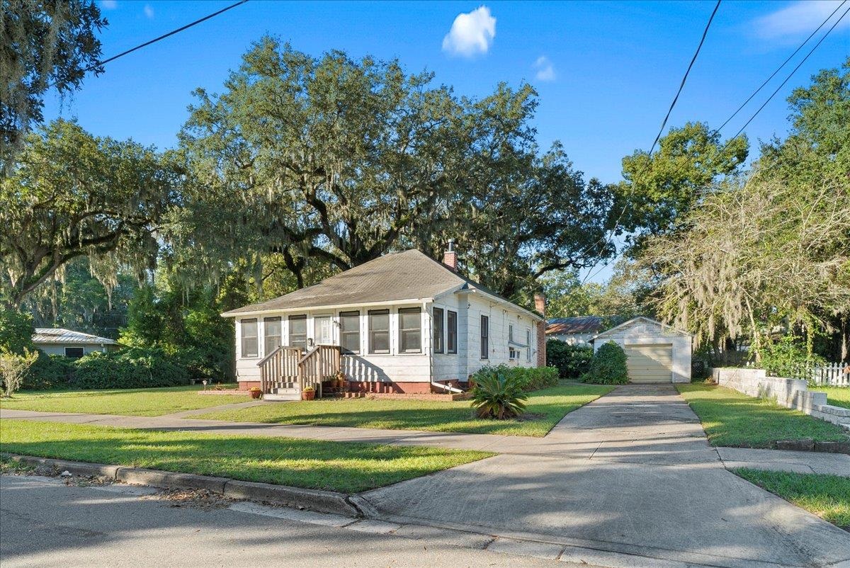 10 Clark Street St. Augustine, FL 32084 - Photo 3 of 44 a front view of a house with a yard table and chairs
