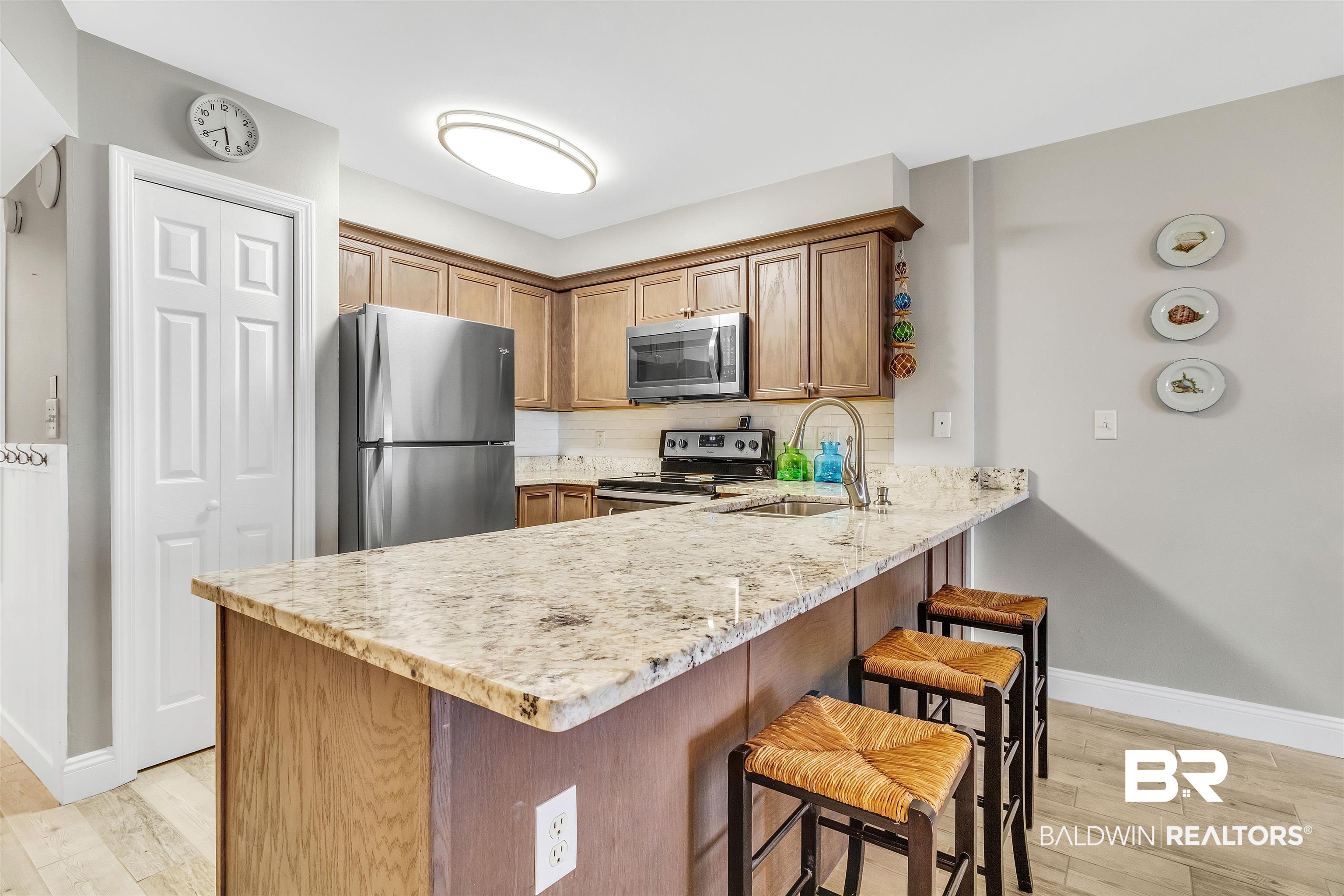 645 Plantation Road, Unit 6404 Gulf Shores, AL 36542 - Photo 6 of 21 UPDATED KITCHEN CABINETS, GRANITE, STAINLESS APPLIANCES