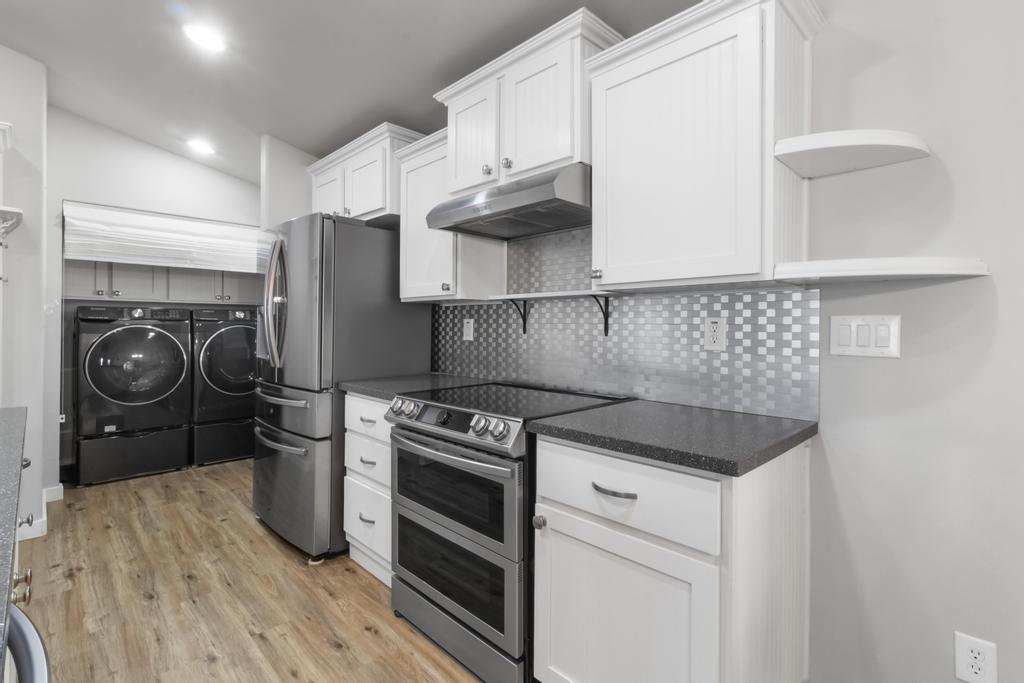 1545 East El Rodeo Road, Unit 42 Fort Mohave, AZ 86426 - Photo 21 of 45 a kitchen with stainless steel appliances granite countertop a stove and a refrigerator