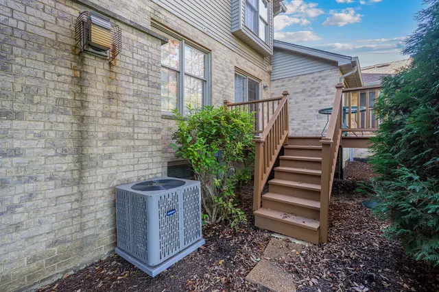 a view of a backyard with plants and brick wall