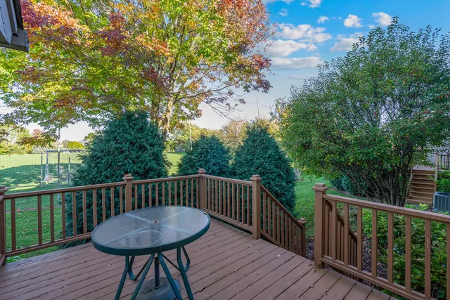 a view of a wooden bench on the roof deck