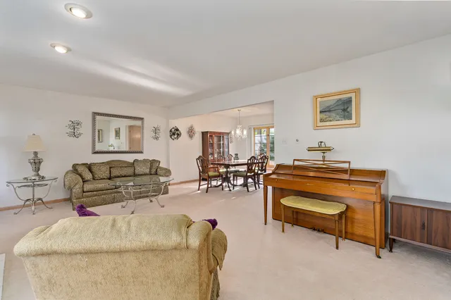a living room with furniture and a piano