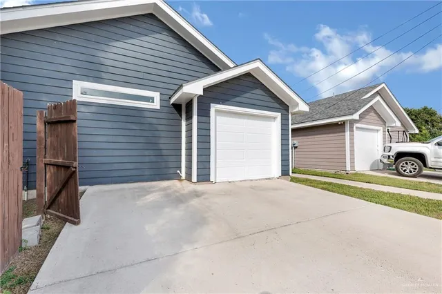 a view of a house with a yard and garage