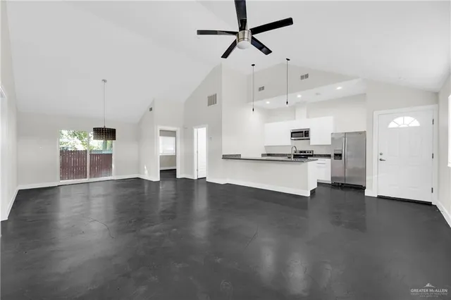 a view of kitchen with stove and wooden floor