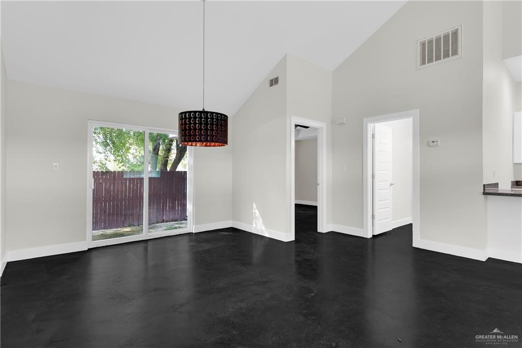 308 North 17th Street, Unit B McAllen, TX 78501 - Photo 7 of 19 wooden floor in an empty room with a window