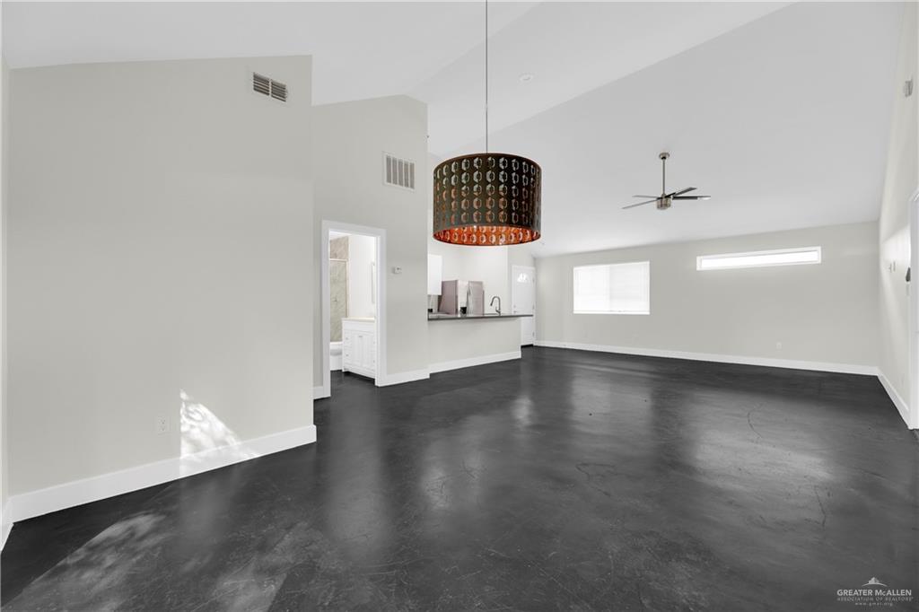 308 North 17th Street, Unit B McAllen, TX 78501 - Photo 8 of 19 an empty room with wooden floor and windows