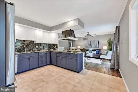 a kitchen with stainless steel appliances granite countertop a stove sink and cabinets