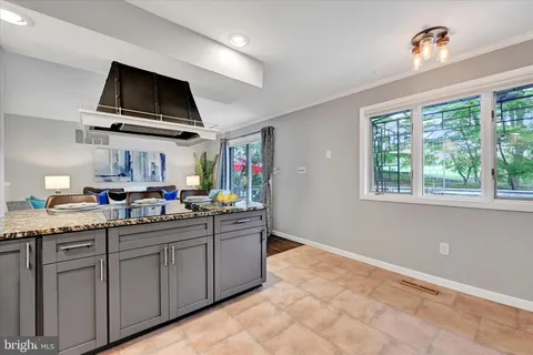 a kitchen with stainless steel appliances a sink stove and cabinets