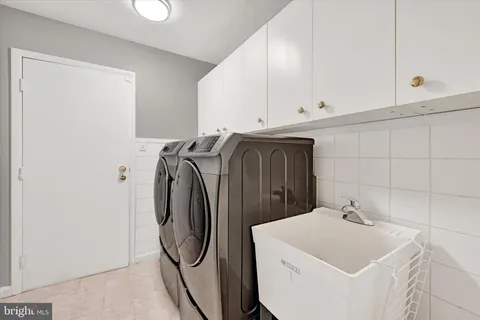 a bathroom with a sink and washing machine