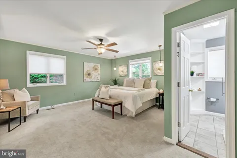 a spacious bedroom with a bed and window