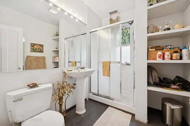 a bathroom with a sink a toilet and shower curtain