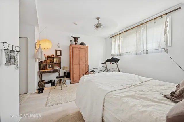 a bed room with a bed window and table