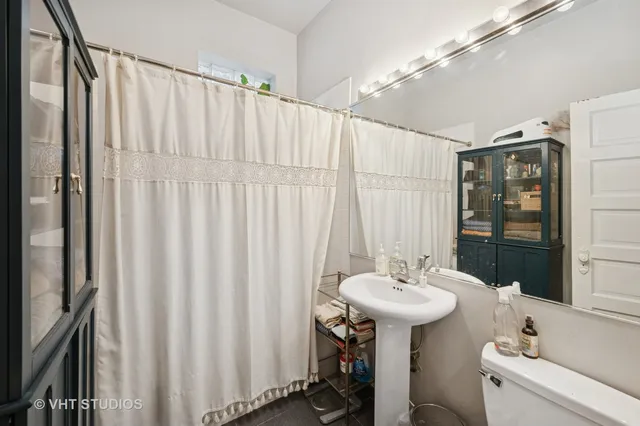 a bathroom with a sink a mirror and a shower curtain
