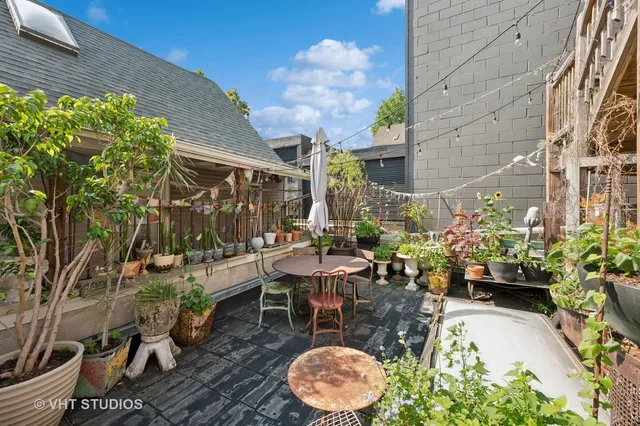 a view of a patio with couches table and chairs and potted plants