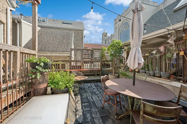 a backyard of a house with table and chairs