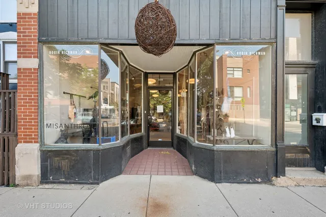 a room with painting on the wall and a window