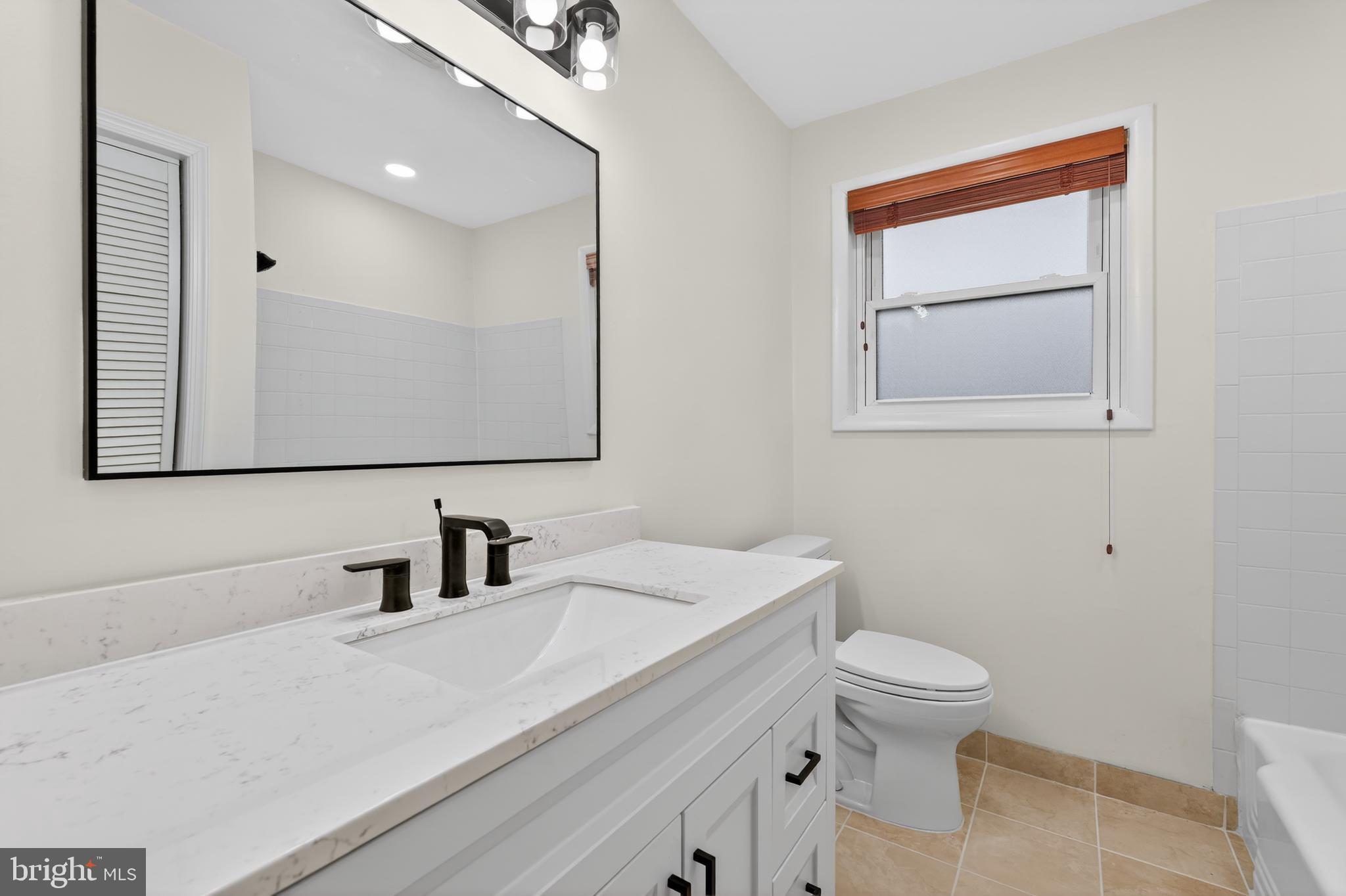 1132 Loxford Terrace Silver Spring, MD 20901 - Photo 17 of 30 a bathroom with a sink a toilet and mirror