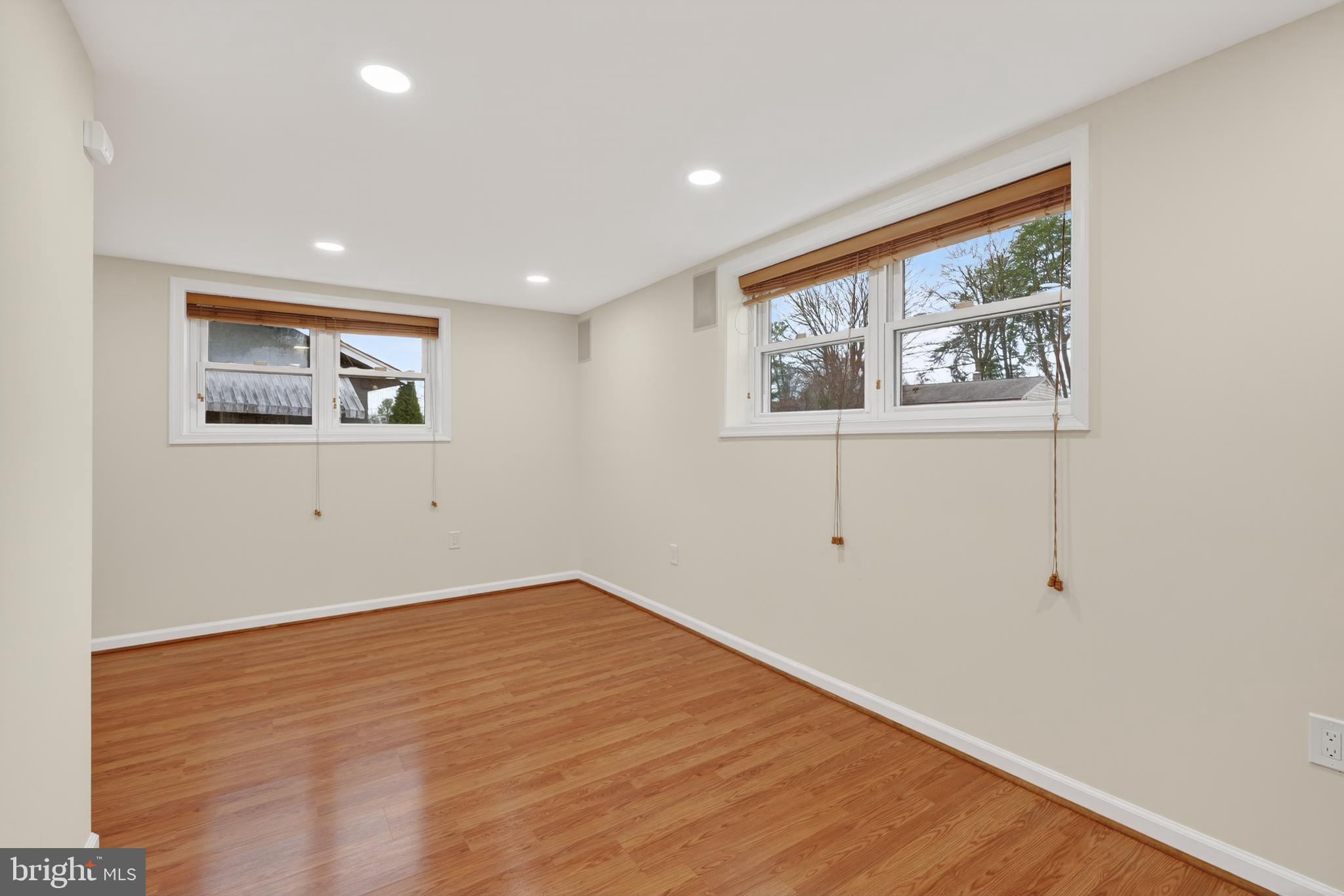 1132 Loxford Terrace Silver Spring, MD 20901 - Photo 19 of 30 a view of an empty room with wooden floor and a window