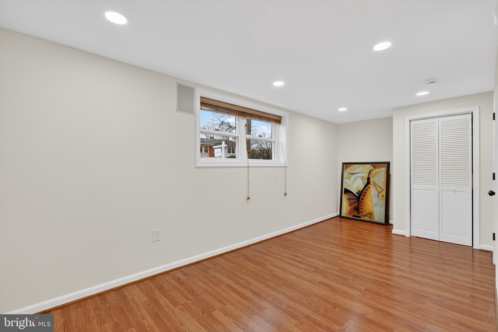 1132 Loxford Terrace Silver Spring, MD 20901 - Photo 20 of 30 a view of an empty room with wooden floor and a window