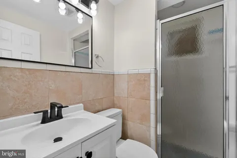 a bathroom with a sink mirror and toilet