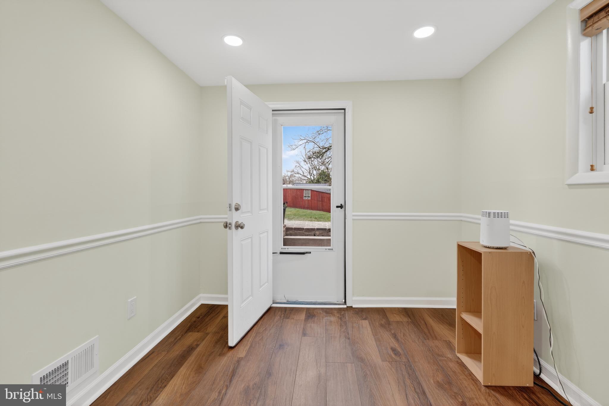 1132 Loxford Terrace Silver Spring, MD 20901 - Photo 23 of 30 a view of an empty room with wooden floor