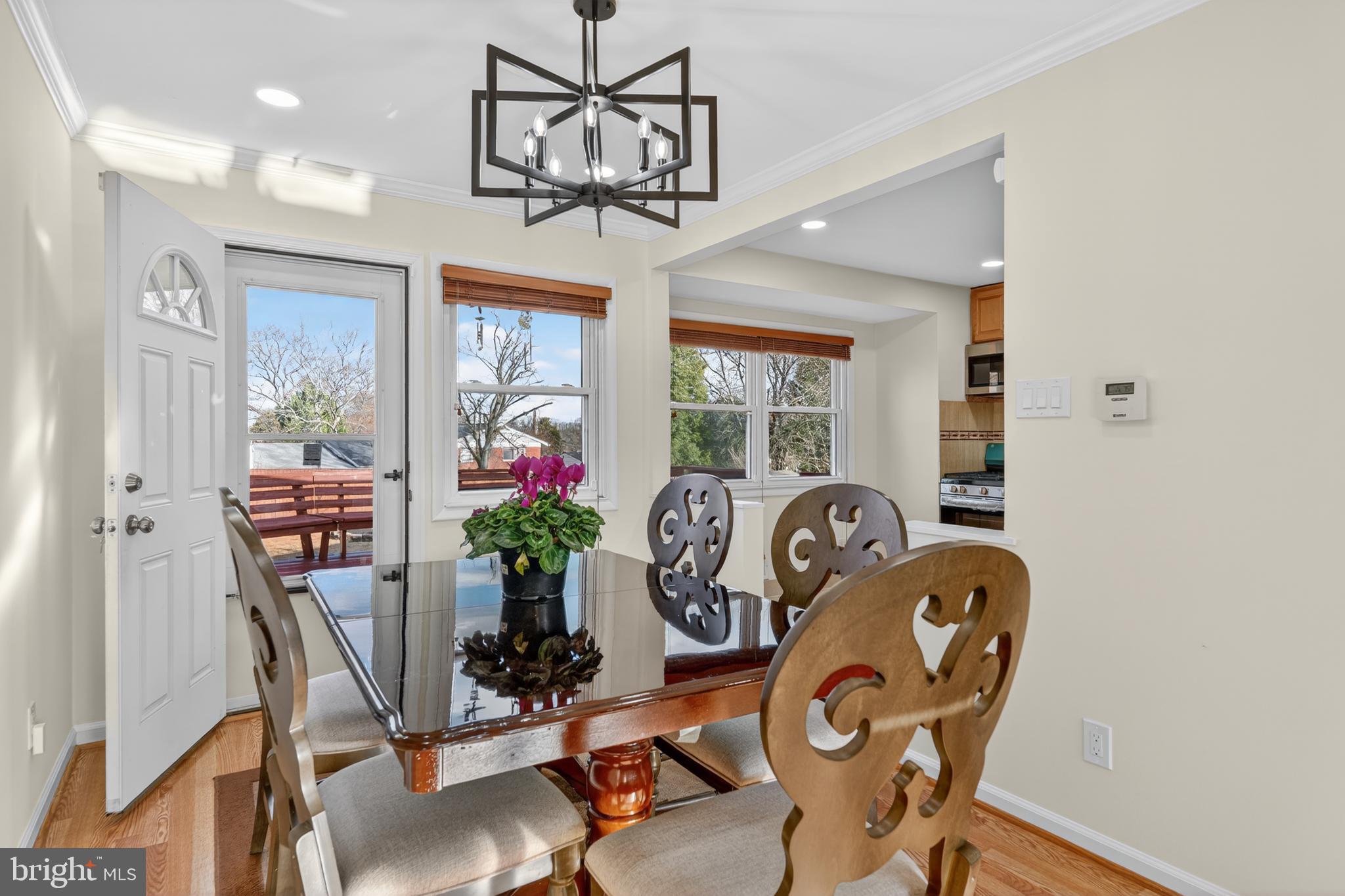 1132 Loxford Terrace Silver Spring, MD 20901 - Photo 6 of 30 a dining room with furniture potted plants and wooden floor