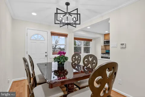 a view of a dining room with furniture and chandelier