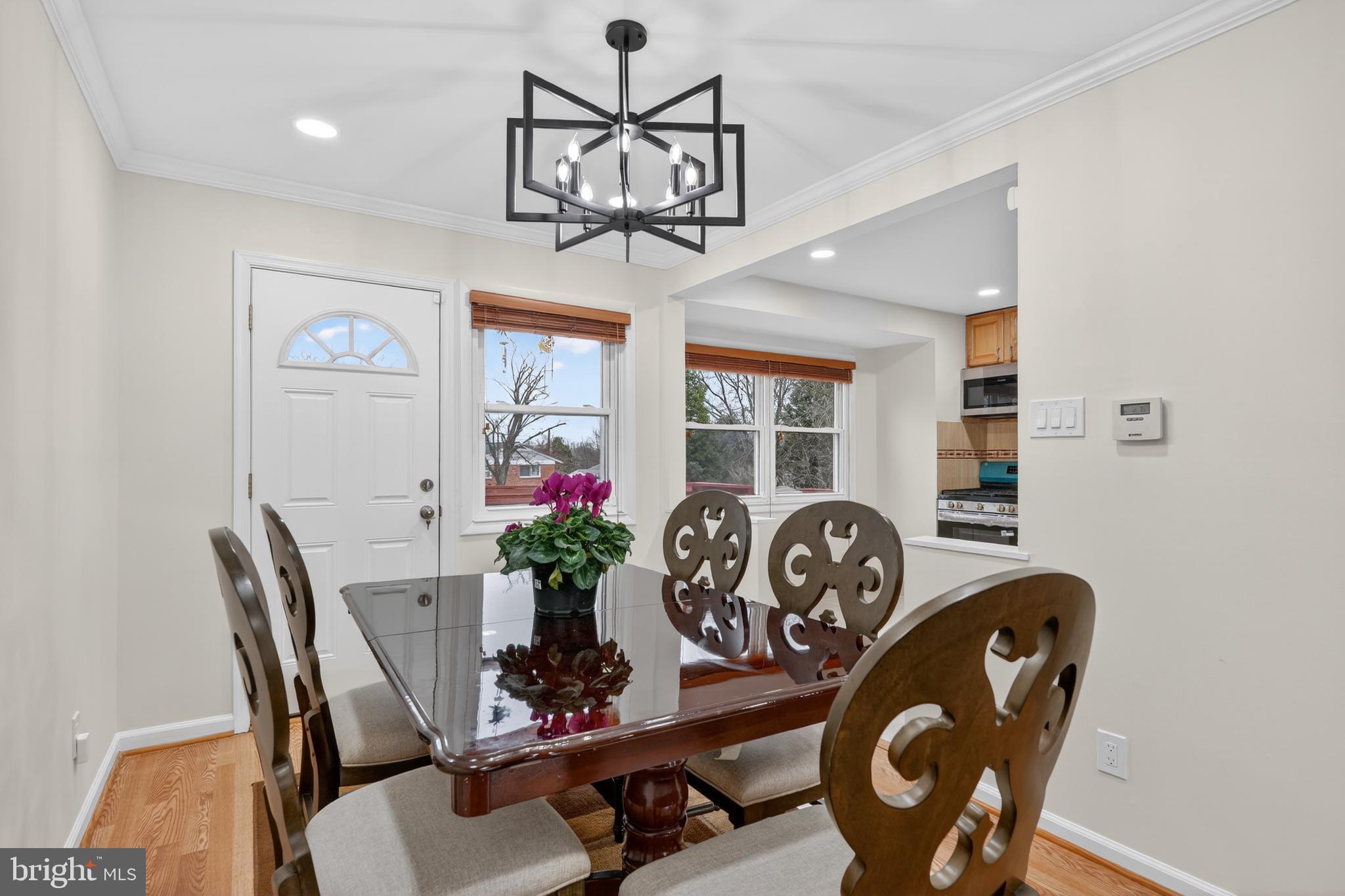 1132 Loxford Terrace Silver Spring, MD 20901 - Photo 7 of 30 a view of a dining room with furniture and chandelier