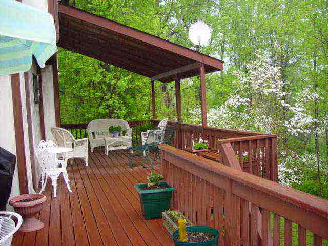 a view of a wooden deck with furniture