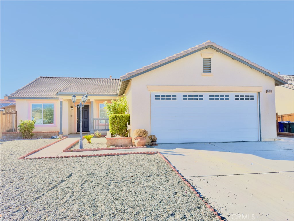 15036 Carrolton Street Adelanto, CA 92301 - Photo 1 of 23 a front view of a house with a outdoor space