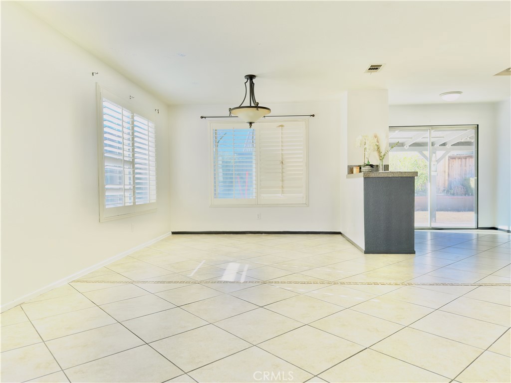 15036 Carrolton Street Adelanto, CA 92301 - Photo 11 of 23 an empty room with windows and cabinet