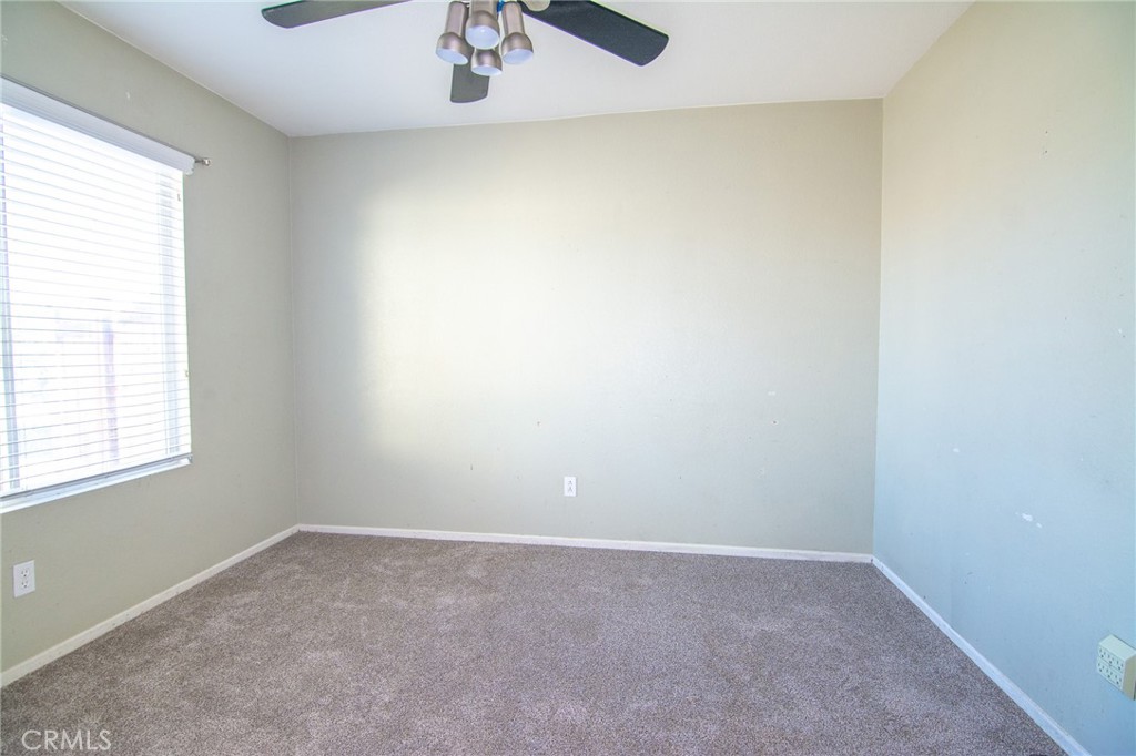15036 Carrolton Street Adelanto, CA 92301 - Photo 15 of 23 an empty room with a window