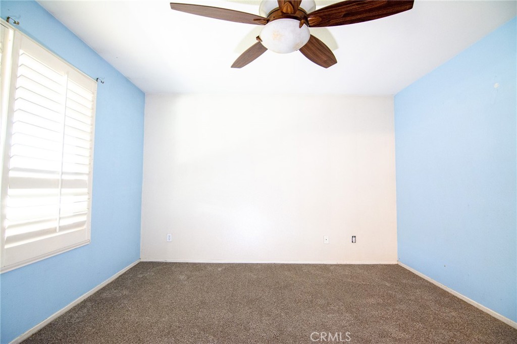 15036 Carrolton Street Adelanto, CA 92301 - Photo 16 of 23 an empty room with windows and fan