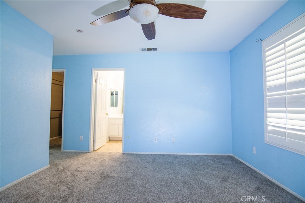 15036 Carrolton Street Adelanto, CA 92301 - Photo 17 of 23 an empty room with windows and closet