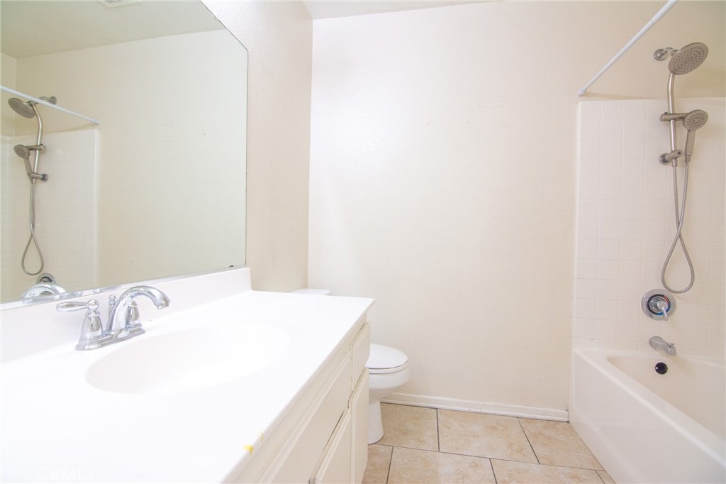 15036 Carrolton Street Adelanto, CA 92301 - Photo 19 of 23 a bathroom with a sink a toilet and shower