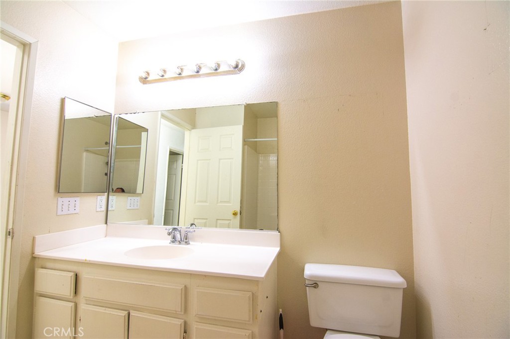 15036 Carrolton Street Adelanto, CA 92301 - Photo 20 of 23 a bathroom with a sink and a mirror