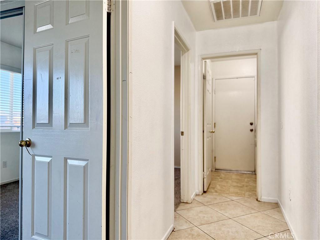 15036 Carrolton Street Adelanto, CA 92301 - Photo 5 of 23 a view of a hallway with closet and bathroom