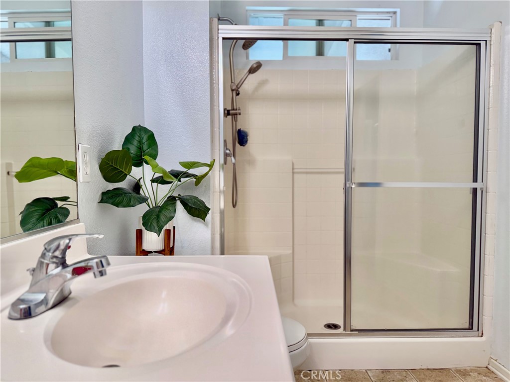 15036 Carrolton Street Adelanto, CA 92301 - Photo 9 of 23 a bathroom with a sink and a mirror